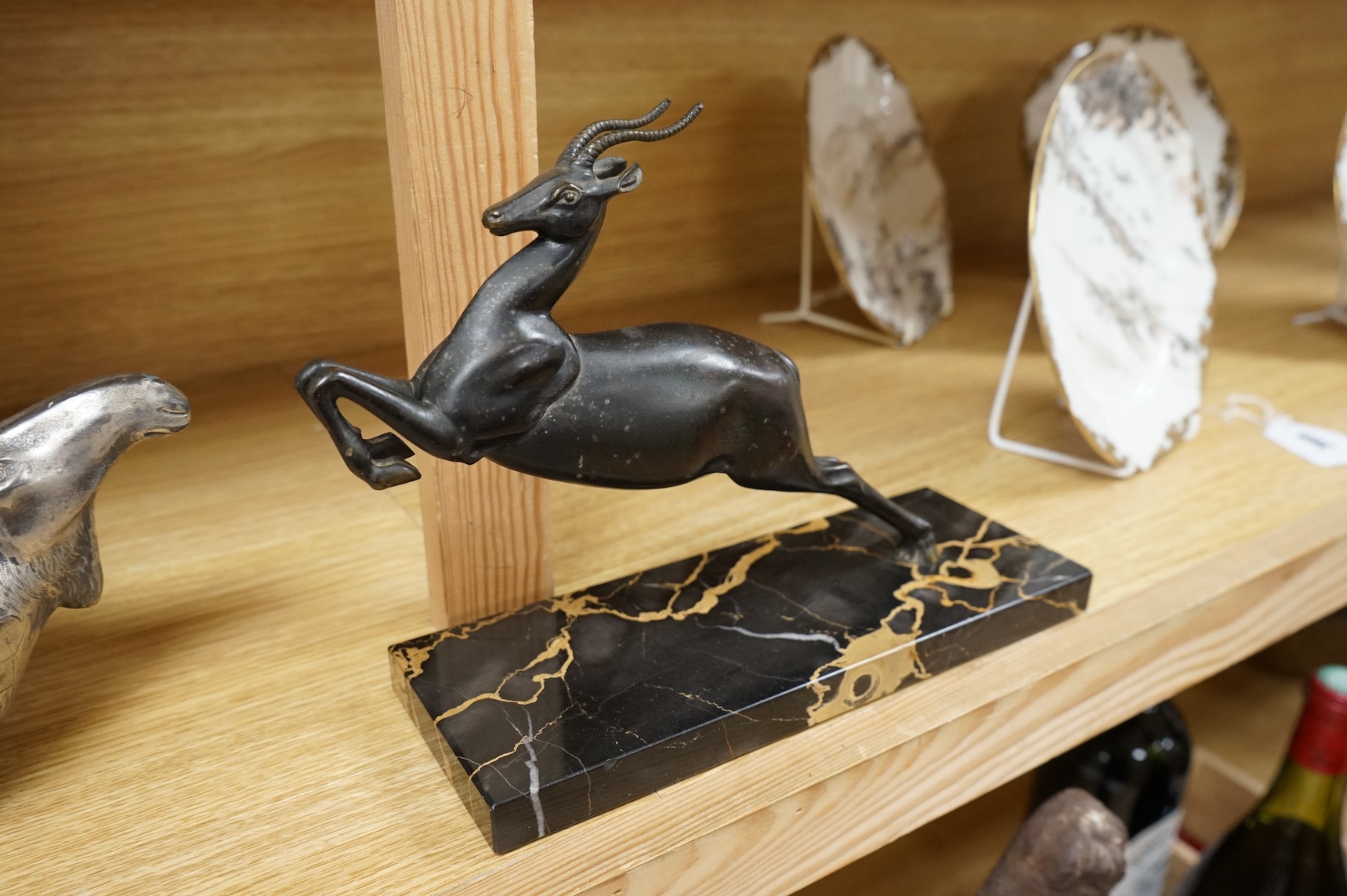 An Art Deco spelter study of a leaping gazelle, 27cm wide